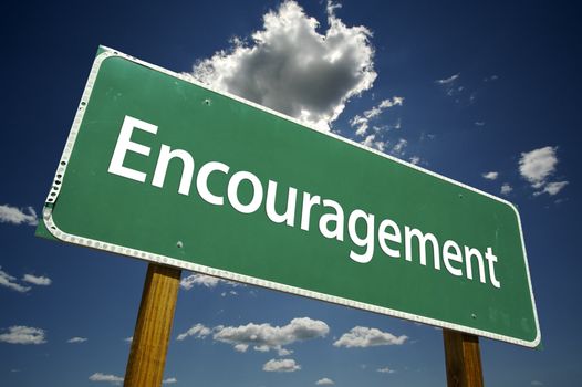 Encouragement Road Sign with dramatic clouds and sky.