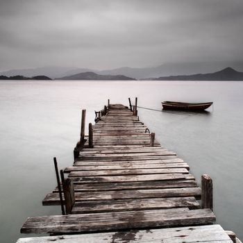 Looking over a pier and a boat, low saturation