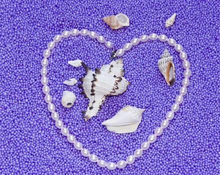 The image heart from pearls beads on a lilac background