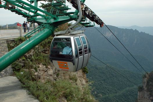 China, Hunan province - national park ZhangJiaJie, cable car. Unique landscape with trees, bushes, hills and cliffs.