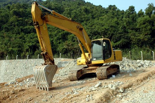 China, Shenzhen city suburb, road under construction with typical digger.