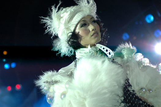 CHINA, SHANGHAI - DECEMBER 31, 2007: Chinese fashion show for New Year's Eve, glamorous carnival clothes, model wearing white fur.