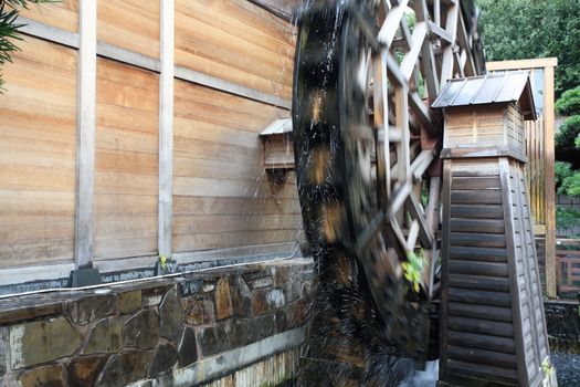 a wooden waterwheel is rotating