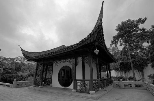 a chinese hut with nice roof, black and white
