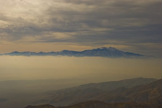 Mountain rises above thick fog