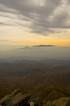 Mountain rises above thick fog