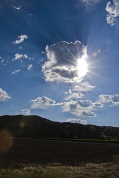 Sun shines through clouds