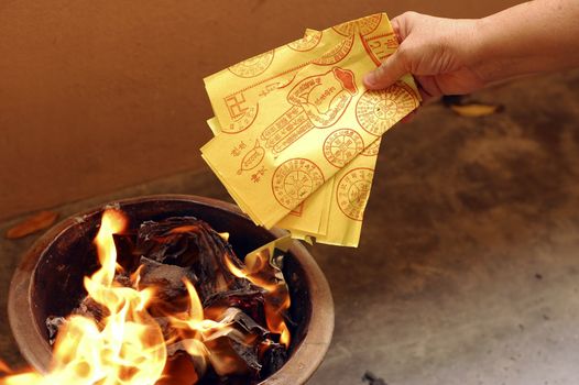 A typical burning fake money and gold for ancestors during Chinese Hungry Ghost Festival