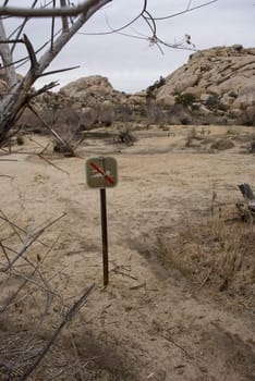 No swimming sign at a dried lake bed