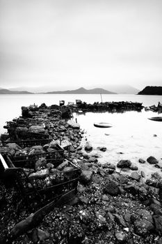 some wasted stuffs at the coastline, black and white