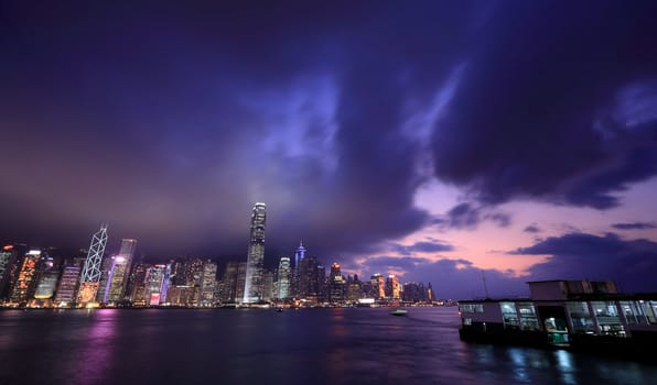 Hong Kong skyline at night, with dramatic sky