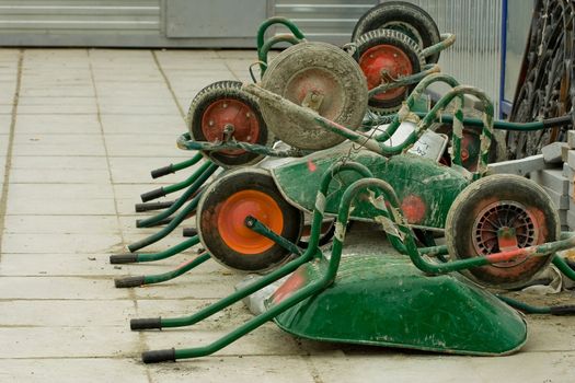 several wheelbarrows on a street