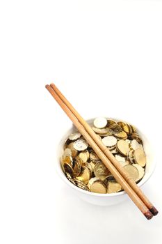 a bowl of money with chopsticks