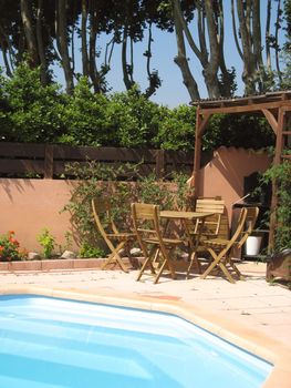 table and chairs by the pool for nice moments