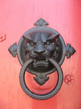 Lion knocker on a Provence church entrance door