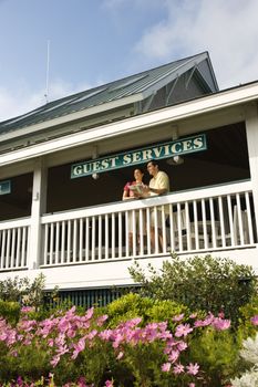 Mid-adult couple on deck of guest services at Bald Head Island, North Carolina.