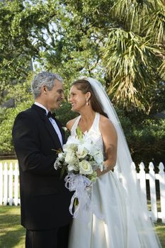 Portrait of bride and groom looking at each other.