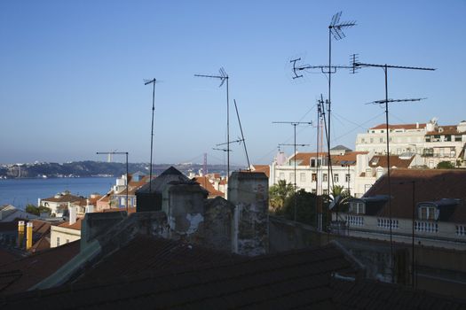 Urban rooftop scene with many antennas in Lisbon, Portugal.