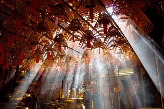 Incense and crepuscular rays in Man mo temple, Hong Kong