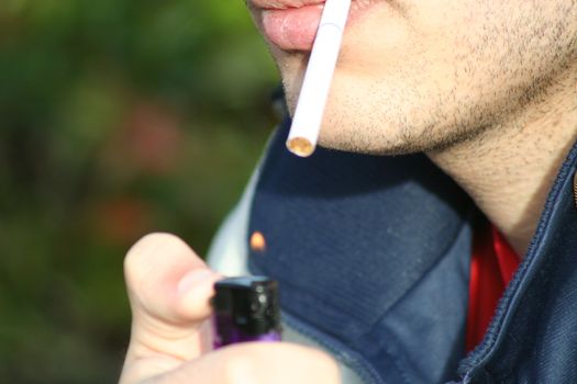 Close up of a person smoking a cigarette.