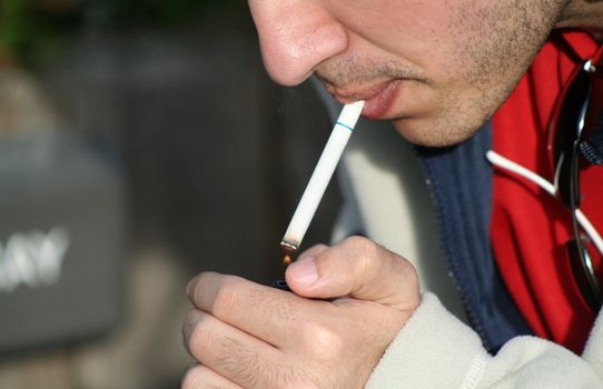 Close up of a person smoking a cigarette.