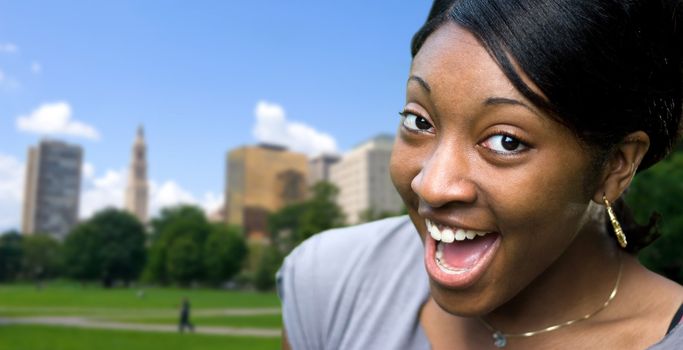 A happy or surprised young black woman posing in Hartford Connecticut.