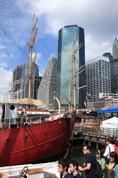 Tourists explore lower Manhattan skyline and fish market