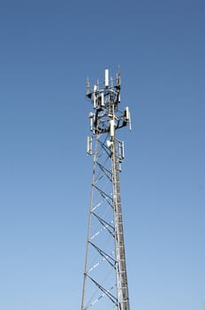 A phone mast against a clear blue sky
