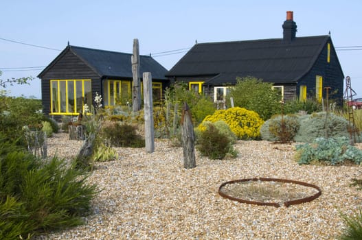 A wooden house with a shingle garden