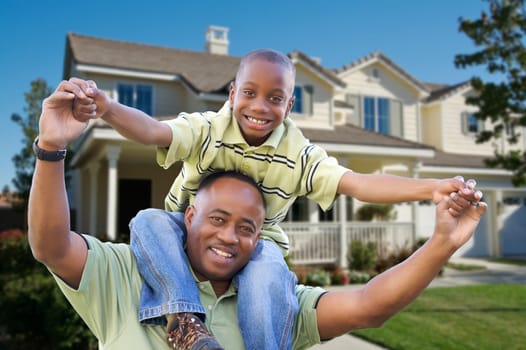 Playful African American Father and Son In Front Yard of Home.