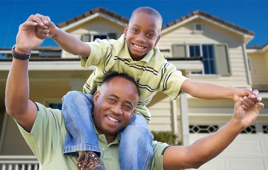 Playful African American Father and Son In Front Yard of Home.