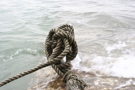 Manila Rope moored in a steel by the beach 