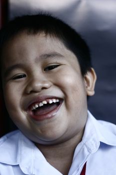 portrait of an asian boy getting ready for school
