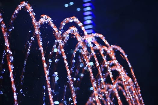 Close up shot of water drops of fountain at night
