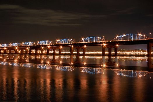 Reflection of Bridge at night and Seoul Skyline at Han River