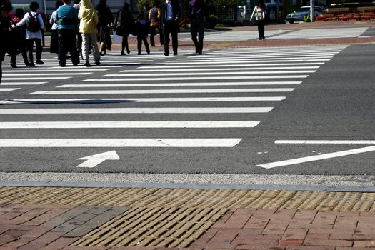 Padestrian Crosswalkers in Seoul Korea focus on the road 