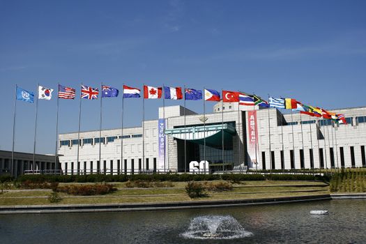 Flags of many countries waving to the wind in war memorial in South Korea
