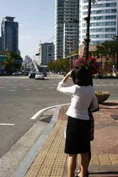 Woman about to cross the street in Seoul Korea