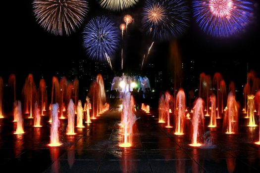 Fountain at night with fireworks nice combination of colors