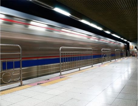 Train coming into subway station with  motion blur 