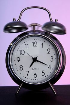 Old fashioned analogue alarm clock ringing for morning wake up