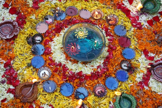 Colorful lamps and flowers arranged beautifully and traditionally during the Diwali festival in India.