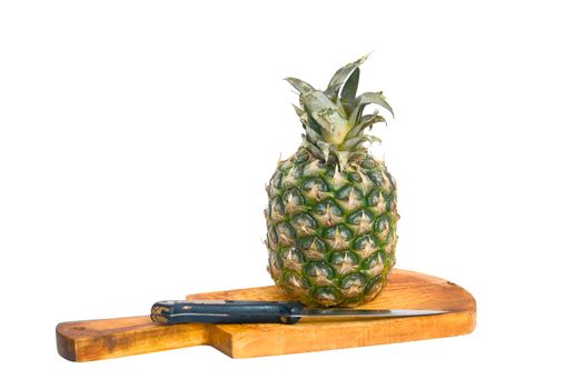 Pineapple, cutting board and knife, isolated on a white background.
