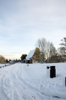 A church covered in snow in a rural setting