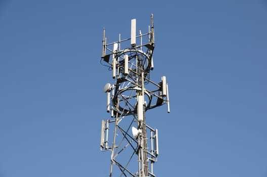 A phone mast against a clear blue sky