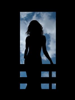 silhouette of a woman on a balcony