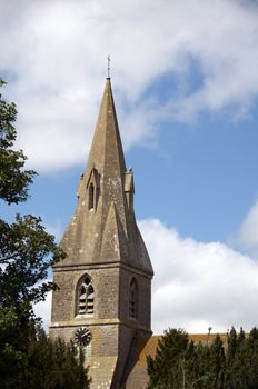 The bell tower of a church with cloudy sky