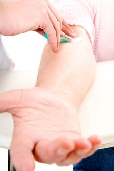 Senior woman arm getting blood analysis.