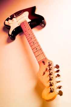 Wide angle shot of an electric guitar with multicolour lighting. 