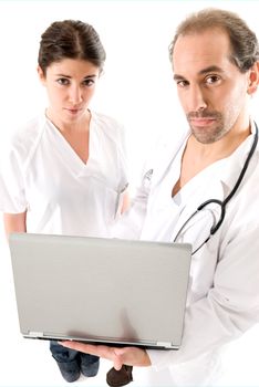 Adult doctor and young nurse with laptop on white backgrund. 